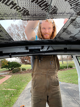 Tyler installing a fan in a van