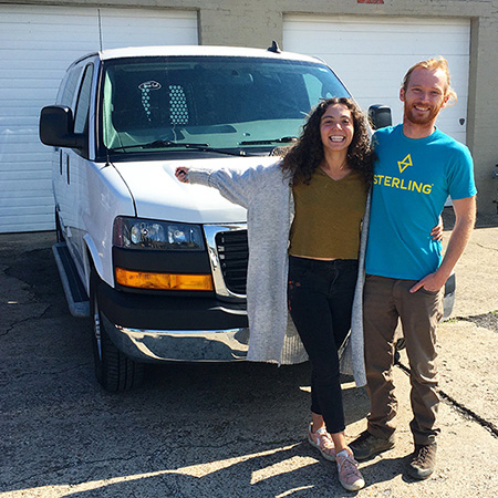 Rachel and Ty in front of their van